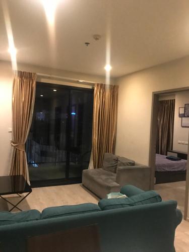a living room with a couch and a window at The base central for family by bobby in Pattaya Central
