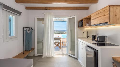 a kitchen with a view of the ocean at Elements of Milos in Mytakas