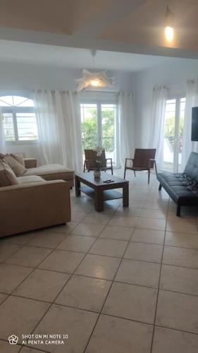 a living room with couches and a table and windows at Eva's house in Kánithos