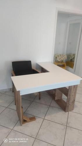 a white desk with a chair in a room at Eva's house in Kánithos