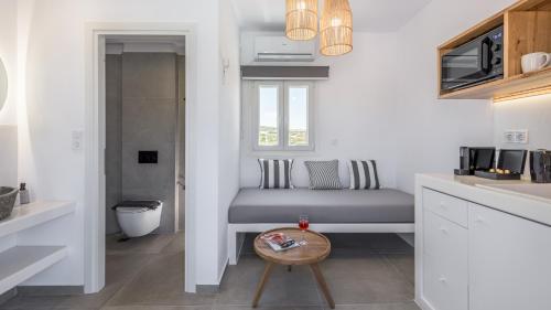 a kitchen with a bench in the middle of a room at Elements of Milos in Mytakas