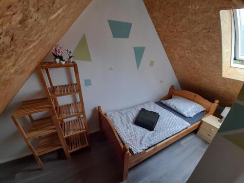 a small bedroom with a bed and a ladder at De´ Borns Ferienwohnung in Rheinsberg