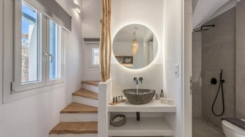a bathroom with a sink and a mirror at Elements of Milos in Mytakas