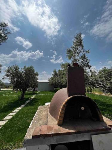 a brick oven in a yard with a grass field at •Naiades Villas• Castalia• in Ladharió