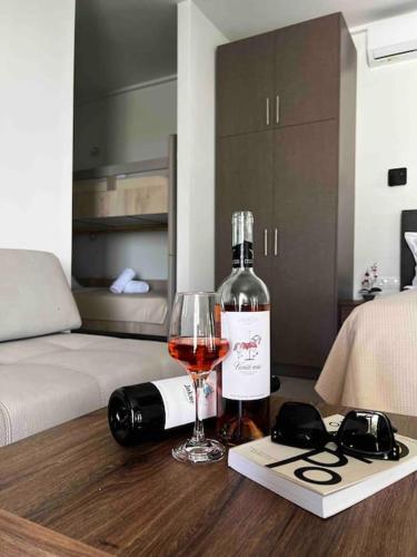 a bottle of wine and a glass on a table at •Naiades Villas• Castalia• in Ladharió