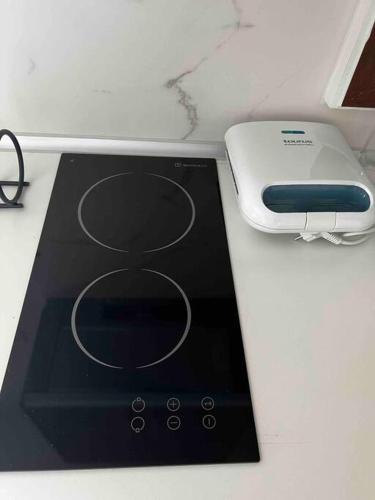a tablet computer sitting on a counter next to a charger at •Naiades Villas• Castalia• in Ladharió