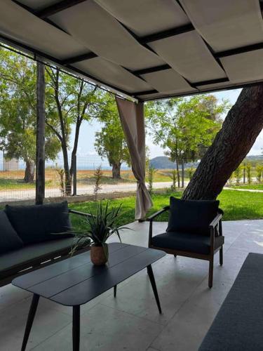 a patio with two couches and a table and chairs at •Naiades Villas• Castalia• in Ladharió