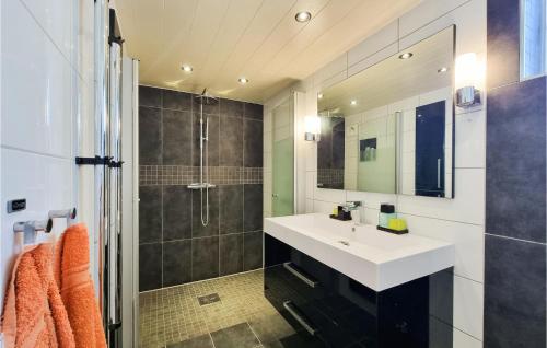 a bathroom with a sink and a shower at Lovely Home In Göteborg With Kitchen in Gothenburg