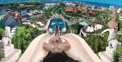 a woman riding a roller coaster at the theme park at Luxury Penthouse Sea View Jacuzzy & pool wiffi free in Playa Fañabe