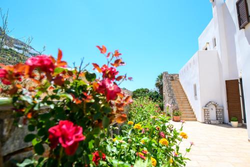un jardín de flores frente a un edificio en Villa Andromeda, en Amorgós