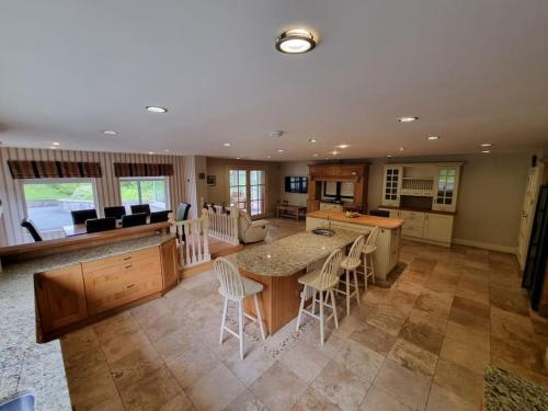 a kitchen and living room with a table and chairs at Gap Retreat in Carrickmore