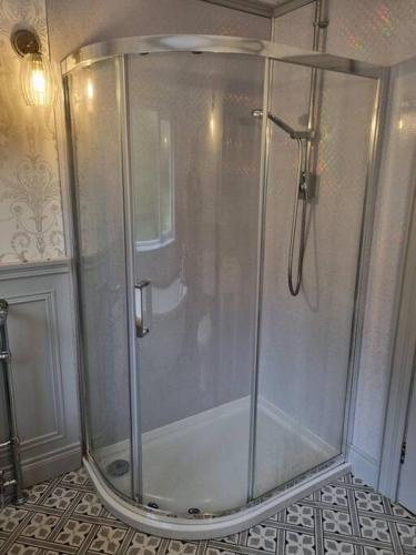 a shower with a glass door in a bathroom at Gap Retreat in Carrickmore