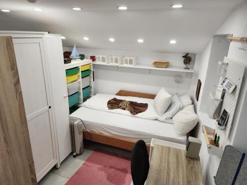 a small bedroom with a bed in a small room at Professor's Krunska Studio in Belgrade