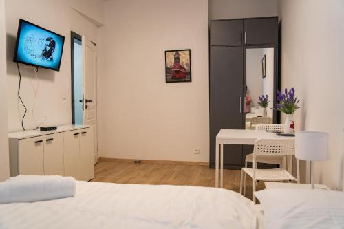 a bedroom with a bed and a table and a tv at Top class apartments in Carlsbad Bulharska street in Karlovy Vary