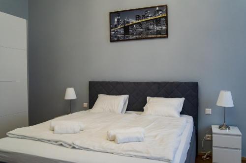 a bedroom with a large white bed with two pillows at Top class apartments in Carlsbad Bulharska street in Karlovy Vary