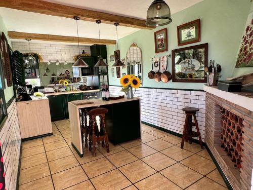 a kitchen with a counter with chairs and a table at Mijas Pueblo paradise villa in Málaga