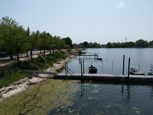 a dock on a lake with boats in the water at Gemütliche 2-Zimmer-Wohnung in Neustadt in Holstein