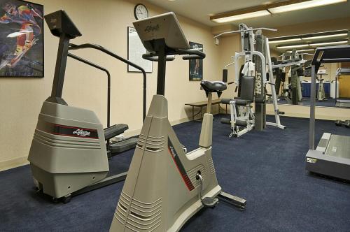 a gym with an elliptical machine and a treadmill at Ramada by Wyndham Bettendorf in Bettendorf