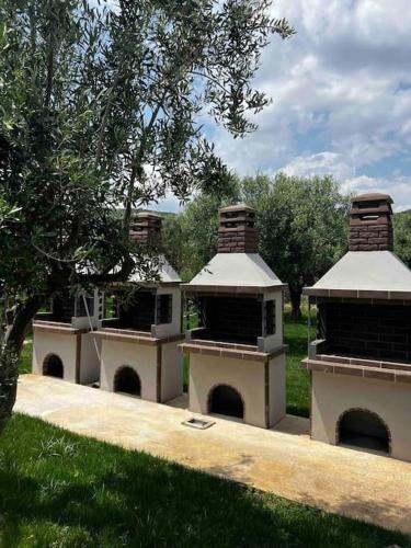 a group of three beehives sitting in a field at •Naiades Villas•Meliti• in Ladharió