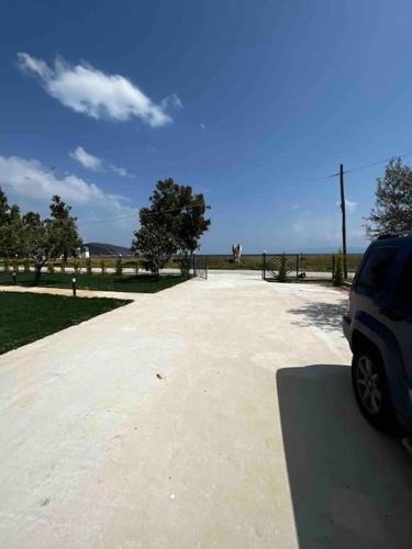 a parking lot with a car parked in a park at •Naiades Villas•Meliti• in Ladharió