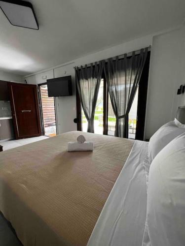 a bedroom with a bed with a white object on it at •Naiades Villas•Meliti• in Ladharió