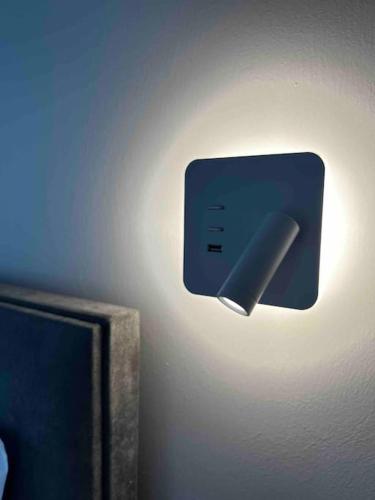a light attached to a wall with a object on it at •Naiades Villas•Meliti• in Ladharió