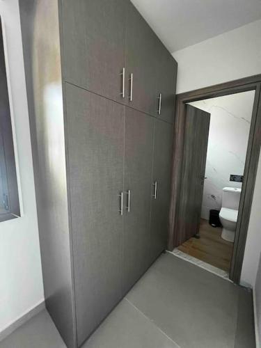 a bathroom with brown cabinets and a toilet at •Naiades Villas•Meliti• in Ladharió