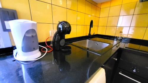 a kitchen with a sink and a phone on a counter at Bela Houses - Porto Center Garden 3 in Porto