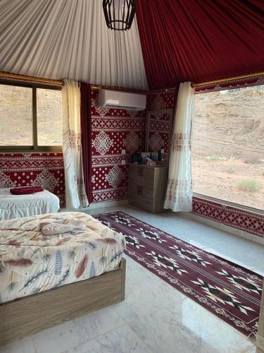 a bedroom with two beds in a tent at Yara camp in Wadi Rum
