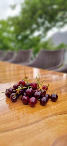 a bunch of cherries sitting on top of a wooden table at Royal's Villa by Premiere Inn, Hunza in Hunza