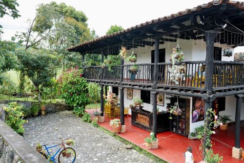 a house with a balcony on the side of it at Hotel Anacaona in San Agustín