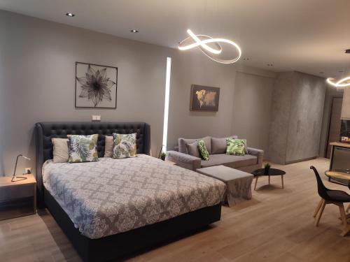 a bedroom with a bed and a couch at Amazing Apartments @ Monastiraki Subway Station in Athens