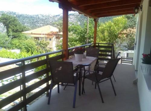 a patio with a table and chairs on a balcony at Poli's Ideal Holiday Home - Fully renovated ! in Rakhónion