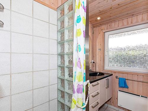 a kitchen with a glass block window and a sink at 7 person holiday home in Højslev-By Traum in Højslev