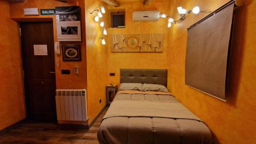 a small bedroom with two beds in a room at El loft de San juan VUT09468 in Burgos