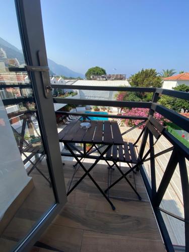 a table and a chair on a balcony at On Oda Oludeniz in Oludeniz