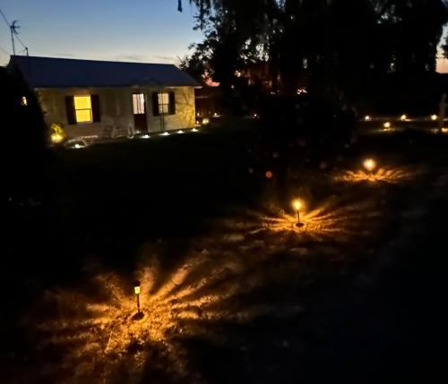 a yard lit up at night with lights at NEW Private House A with Carports EV Plugin L2 in Twin Falls