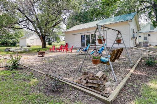 a playground in a yard with a swing at Coffeyville Countryside Studio with Fire Pit! in Coffeyville
