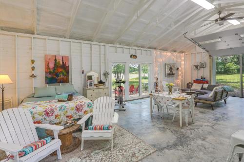 a bedroom with a bed and a table and chairs at Coffeyville Countryside Studio with Fire Pit! in Coffeyville
