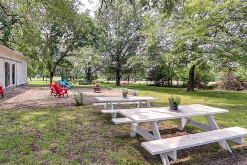 a group of picnic tables in a park at Coffeyville Countryside Studio with Fire Pit! in Coffeyville