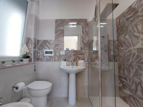 a bathroom with a toilet and a sink and a shower at Siracusa Ortigia by Duomo in Siracusa