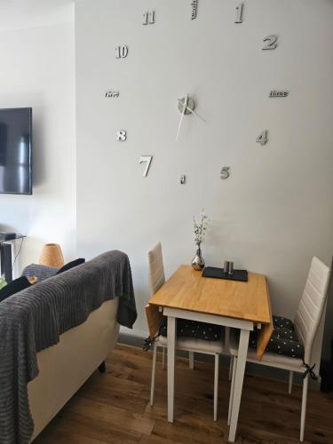 a bedroom with a table and a bed and a table and chairs at Modern One-bedroom flat in Maidstone in Maidstone