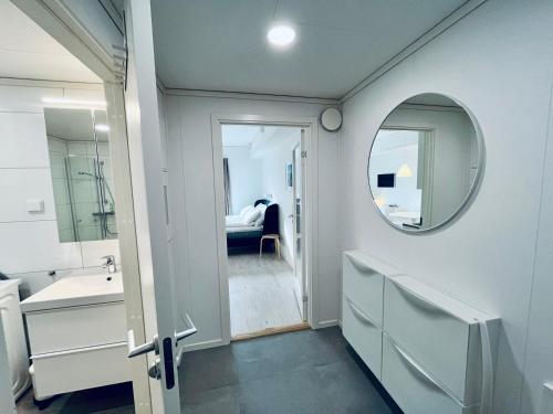 a bathroom with a sink and a mirror at Lofoten Studio Penthouse in Svolvær