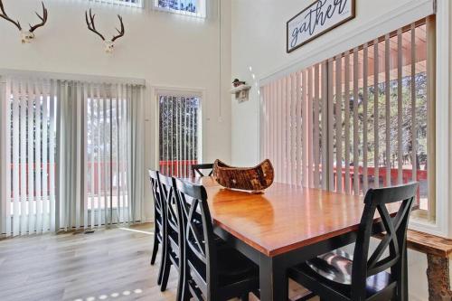 a dining room with a wooden table and chairs at Cascade Cabin Mountain Getaway with Private Beach in Cascade