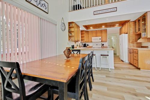 a kitchen and dining room with a wooden table and chairs at Cascade Cabin Mountain Getaway with Private Beach in Cascade