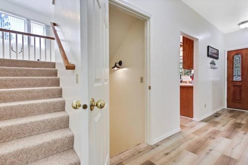 a staircase in a home with white walls and wooden floors at Cascade Cabin Mountain Getaway with Private Beach in Cascade