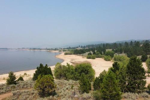 a view of a beach with trees and water at Cascade Cabin Mountain Getaway with Private Beach in Cascade
