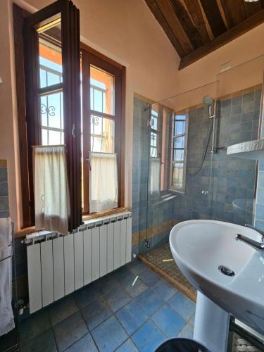 a bathroom with a tub and a sink and a shower at La Casa dei Tigli in Cannara