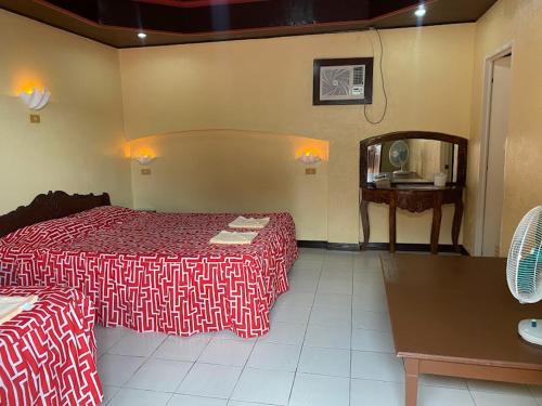 a hotel room with two beds and a mirror at Napo Beach Resort in Maripipi