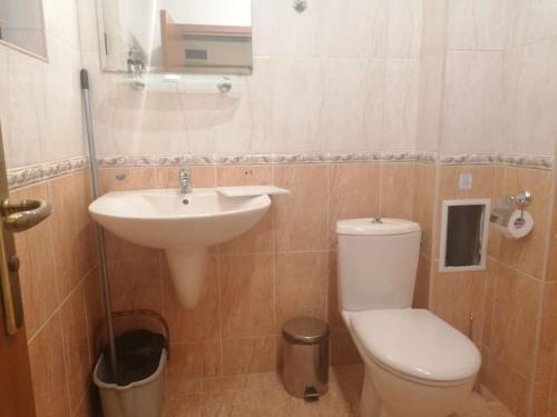 a bathroom with a toilet and a sink at Spacious Fully Furnished Studio in Kavarna Apart Hotel in Kavarna